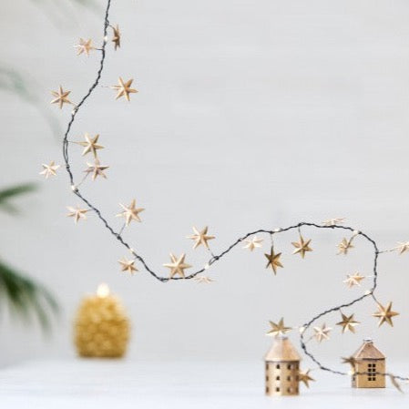 Gold star garland with gold house decorations