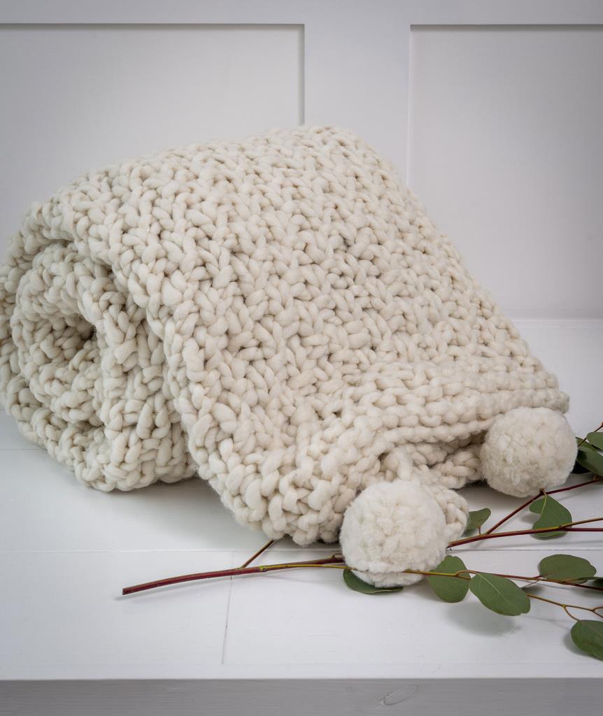 Chunky knitted cream throw with Pom poms