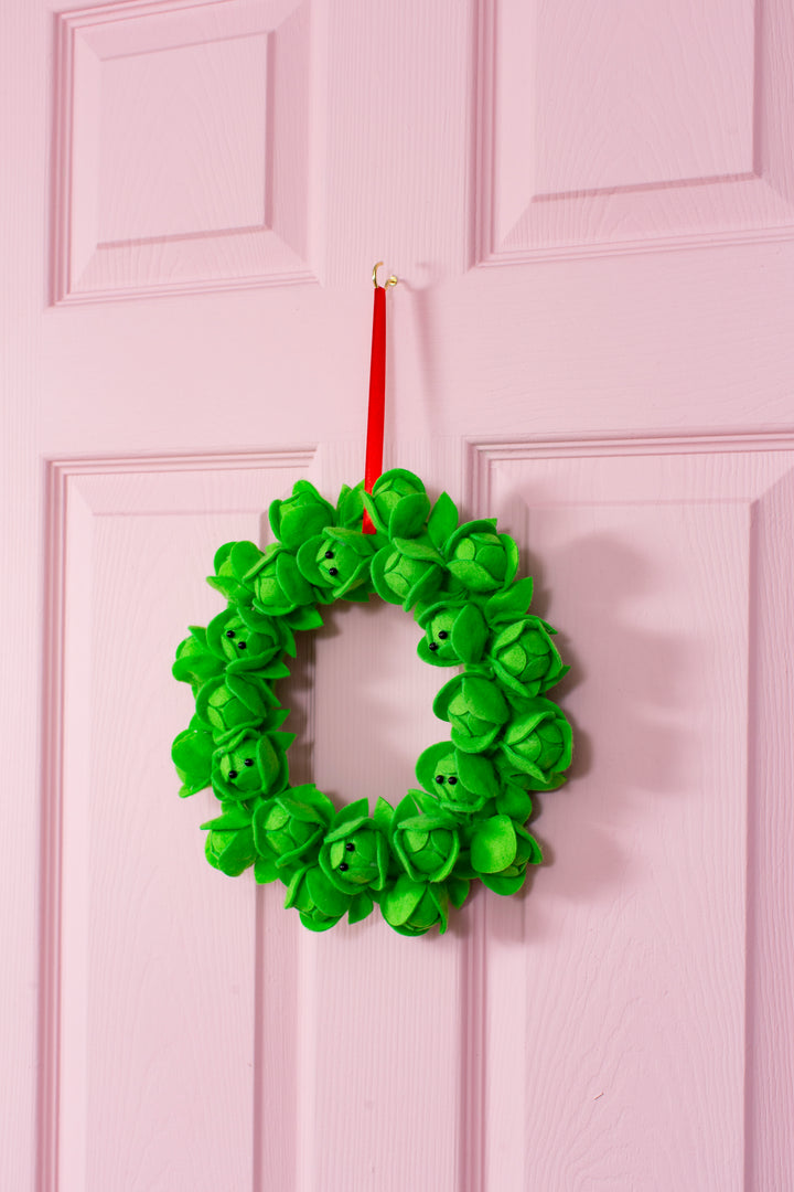 brussel sprout wreath on a pink door