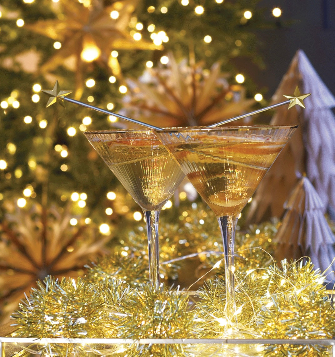 cocktail glasses with star cocktail stirrers and tinsel